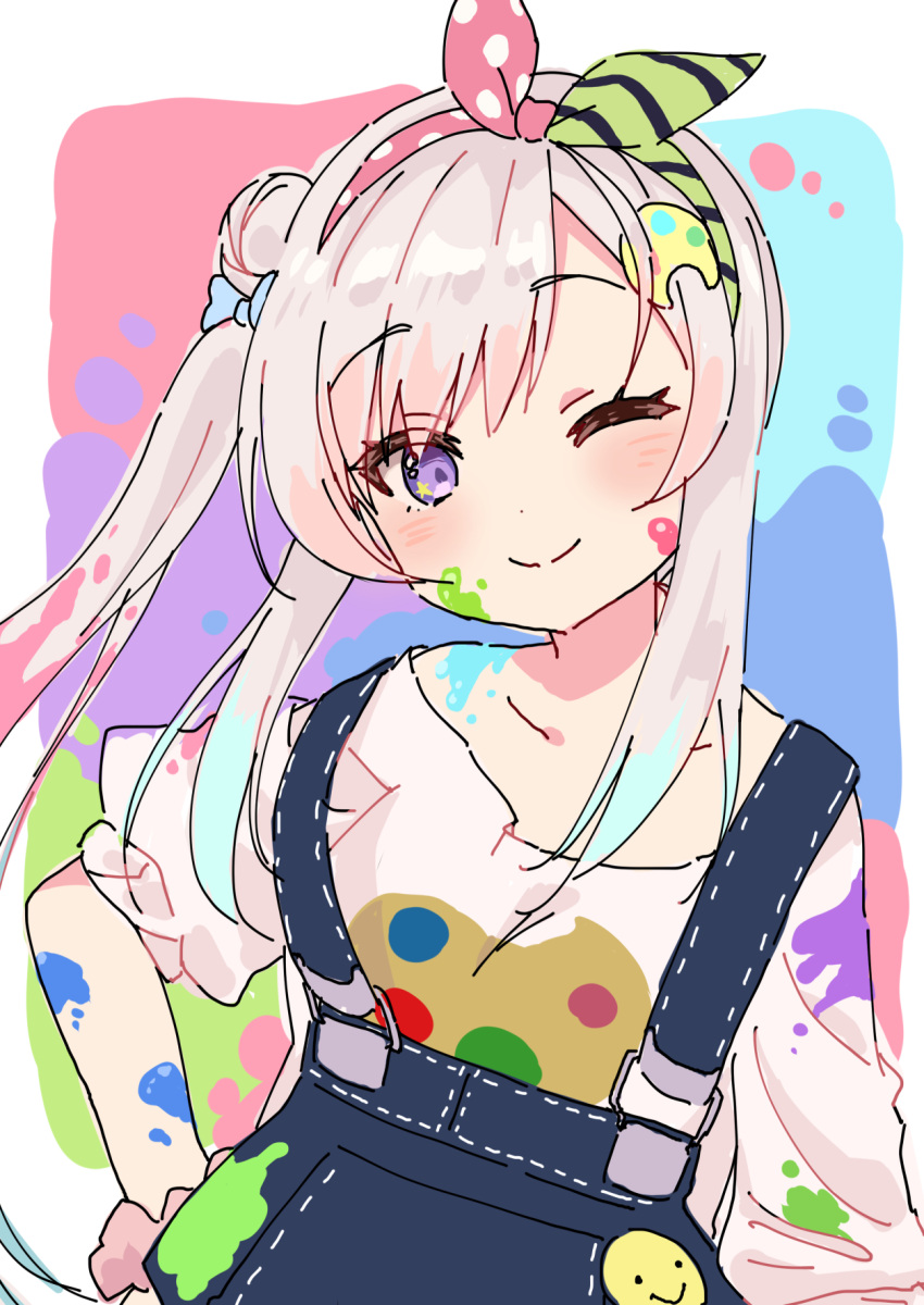 1girl airani_iofifteen bangs blue_bow blue_overalls bow eyebrows_visible_through_hair green_hairband hair_bun hairband highres hololive hololive_indonesia houshou_marine_(artist) looking_at_viewer one_eye_closed overalls paint_in_hair paint_on_body paint_on_clothes paint_on_face paint_stains palette_hair_ornament pink_hair pink_hairband purple_eyes shirt side_ponytail sidelocks smiley_face solo white_shirt