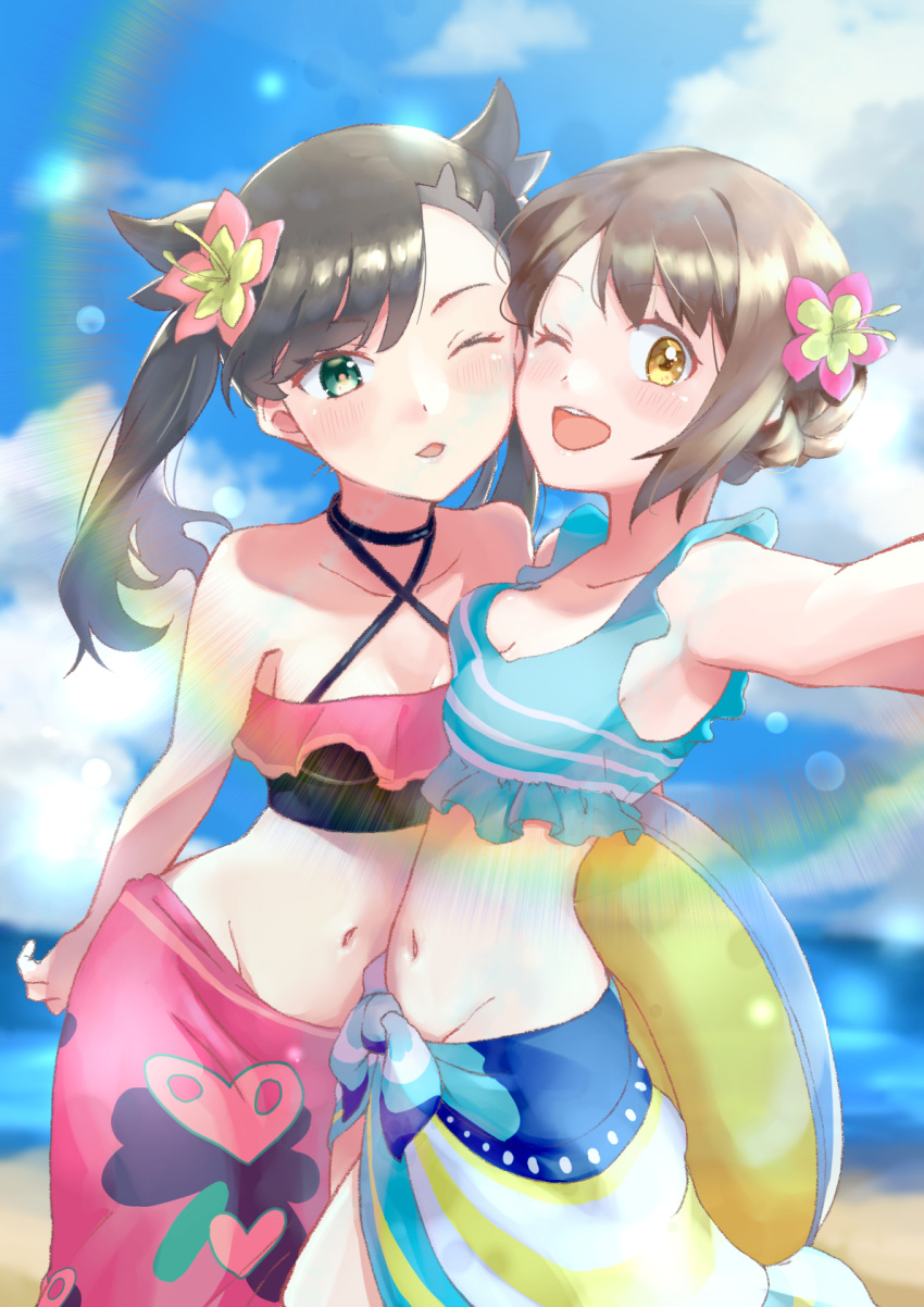 2girls arm_behind_back asymmetrical_bangs bangs beach bikini black_hair blush breasts brown_hair cheek-to-cheek choker cleavage day flower frills gloria_(pokemon) green_eyes hair_flower hair_ornament heads_together hibiscus highres holding holding_innertube innertube kamonohashi_(19881001) lens_flare long_hair marnie_(pokemon) multiple_girls navel ocean official_alternate_costume one_eye_closed open_mouth parted_lips pokemon pokemon_(game) pokemon_masters_ex rainbow sarong short_hair small_breasts sunlight swimsuit twintails two_side_up yellow_eyes yuri