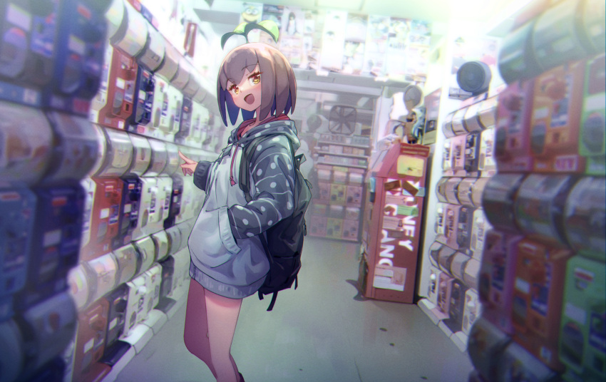 1girl atm backpack bag blurry brown_hair chromatic_aberration commentary_request depth_of_field despicable_me electric_fan eva_mashiro eva_mashiro_(vtuber) feet_out_of_frame gashapon_machine grey_hoodie hand_in_pocket head_tilt highres hood hood_down hoodie indie_virtual_youtuber indoors long_sleeves looking_at_viewer minion_(despicable_me) open_mouth pointing short_hair smile soft_focus solo sprout standing virtual_youtuber yellow_eyes