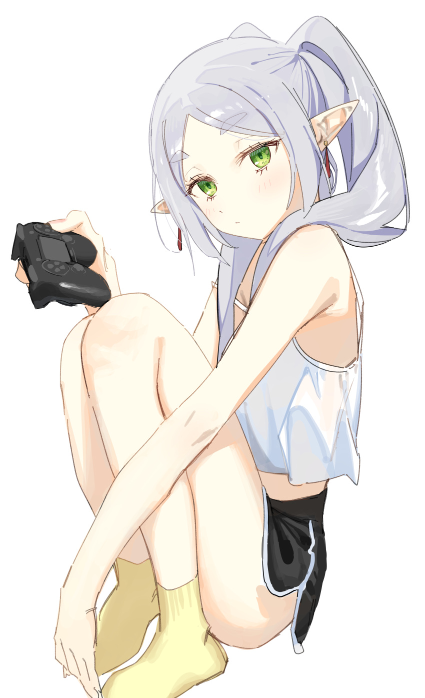 1girl absurdres alternate_costume bare_shoulders black_shorts blush camisole closed_mouth controller elf frieren game_controller green_eyes highres holding long_hair pointy_ears ponytail short_shorts shorts simple_background sitting socks solo sousou_no_frieren syhan twintails white_background white_camisole yellow_socks