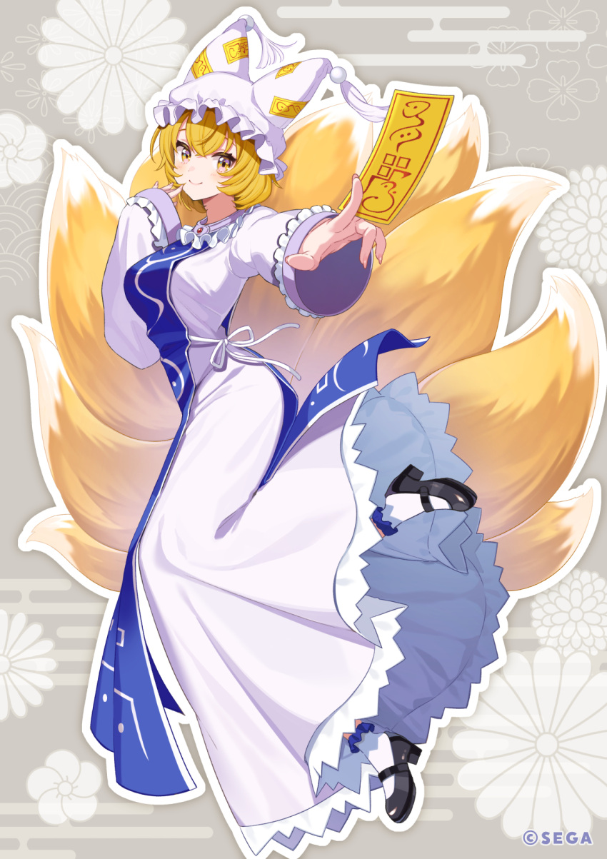 1girl bangs black_footwear blonde_hair blue_tabard breasts commentary_request dress floral_background fox_tail frills full_body hat highres holding large_breasts long_sleeves looking_at_viewer multiple_tails ofuda pillow_hat sega shigure_ui short_hair sleeves_past_wrists smile tail tassel touhou white_dress white_headwear yakumo_ran yellow_eyes