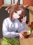  1girl absurdres animal_ears blush bowl brown_hair chopsticks collared_shirt commentary fine_motion_(umamusume) food green_eyes green_skirt hair_between_eyes hair_bun highres himori_kiko holding holding_chopsticks horse_ears horse_girl indoors long_sleeves looking_at_viewer multicolored_hair noodles open_mouth plaid plaid_skirt pleated_skirt ramen shirt short_hair skirt smile solo streaked_hair umamusume white_hair white_shirt 