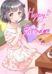  1girl bang_dream! black_hair blurry blurry_background blush cake dated depth_of_field dress floral_print food fork happy_birthday highres holding holding_fork indoors kasaroku looking_at_viewer on_ground red_eyes short_hair sitting smile solo table ushigome_rimi utensil_in_mouth 
