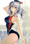  1girl bare_arms bare_legs bare_shoulders beret black_headwear black_swimsuit blue_eyes blush breasts collarbone cowboy_shot eyebrows_visible_through_hair hair_between_eyes hat highres kantai_collection kashima_(kancolle) kasumi_(skchkko) large_breasts long_hair one-piece_swimsuit open_mouth solo swimsuit twintails white_hair 