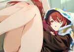  1girl :o bare_legs black_shirt couch debi_tarou hair_ornament highres hood horned_hood horns idolmaster idolmaster_shiny_colors indoors legs_up looking_at_viewer lying mitsuya_ryo no_pants object_hug on_back on_couch osaki_tenka red_hair shirt solo stuffed_toy thighs 