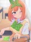  1girl ;) bangs blurry blurry_background blush bow breasts chair closed_mouth collared_shirt commentary_request depth_of_field desk eyebrows_behind_hair go-toubun_no_hanayome green_bow green_ribbon green_skirt hair_ribbon highres indoors kujou_karasuma medium_breasts nakano_yotsuba on_chair one_eye_closed orange_hair pleated_skirt ribbon school_chair school_desk shirt short_sleeves signature sitting skirt smile solo sweater_vest white_shirt wooden_floor 