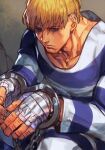  1boy bandaged_hand bandages blonde_hair blue_eyes chain closed_mouth cody_travers cuffs facial_hair hand_wraps handcuffs hungry_clicker male_focus prison_clothes serious sitting solo street_fighter stubble 