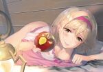  1girl apple bare_legs bed_sheet blonde_hair blush breasts brown_eyes cleavage clothes_lift djeeta_(granblue_fantasy) downblouse food fruit granblue_fantasy hairband highres holding holding_food holding_fruit indoors long_hair looking_at_viewer lying medium_breasts miniskirt naruse_hirofumi no_panties on_stomach parted_lips pink_skirt red_apple red_hairband shiny shiny_hair shirt skirt skirt_lift smile solo white_shirt 
