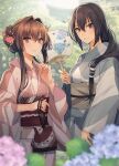  2girls alternate_hairstyle black_hair blush brown_hair bush closed_mouth grey_kimono grin hair_intakes hand_fan highres japanese_clothes kantai_collection kasumi_(skchkko) kimono looking_at_viewer multiple_girls nagato_(kancolle) obi outdoors paper_fan pink_kimono sash sidelocks smile wide_sleeves yamato_(kancolle) 