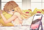  1girl akai_haato bangs blonde_hair blue_eyes blush breast_press breasts cellphone closed_mouth haaton_(akai_haato) hair_between_eyes highres hololive indoors large_breasts light_smile long_hair looking_at_viewer lying makinan nightgown object_hug on_stomach phone pillow pillow_hug shadow smartphone solo strap_slip stuffed_animal stuffed_pig stuffed_toy sunlight virtual_youtuber window 