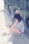  1girl black_hair blue_eyes bottle cellphone flip_phone highres hood hoodie looking_at_viewer medium_hair open_mouth original phone plastic_bottle reia shoes shorts sitting sneakers solo washing_machine 