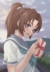  1girl absurdres blue_neckerchief blue_sailor_collar blurry blurry_background blush box brown_hair cloud cloudy_sky field gift gift_box hand_up head_tilt hibike!_euphonium highres holding holding_box kitauji_high_school_uniform long_hair looking_at_viewer looking_to_the_side mountain nakagawa_natsuki neckerchief open_mouth outdoors ponytail purple_eyes raku_rakugaki sailor_collar school_uniform serafuku shirt short_sleeves sky smile solo standing white_shirt 