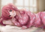  1girl bangs bed_sheet blunt_bangs blurry blurry_background blush breasts button_gap collarbone idolmaster idolmaster_cinderella_girls indoors large_breasts light_particles long_hair looking_at_viewer lying motu7be1024 ogata_chieri on_side open_collar pajamas pillow polka_dot polka_dot_pajamas red_eyes red_pajamas smile solo sunlight twintails 