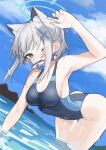  1girl animal_ears arm_up bangs blue_archive blue_eyes breasts cat_ears cleavage competition_swimsuit cross_hair_ornament extra_ears fataaa fish fish_in_mouth grey_hair hair_ornament halo highres kneeling medium_breasts ocean one-piece_swimsuit one_eye_closed outdoors partially_submerged shiroko_(blue_archive) short_hair sideboob sky solo swimsuit wet 