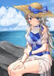  1girl blue_swimsuit blush closed_mouth cloud cloudy_sky day feet_out_of_frame grey_eyes grey_hair hat kantai_collection long_hair mayura2002 ocean rock sarong sitting sky smile solo sun_hat swimsuit washington_(kancolle) white_sarong 