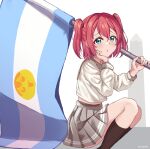  1girl absurdres argentinian_flag bangs chestnut_mouth commentary_request flag green_eyes grey_sailor_collar grey_skirt hair_between_eyes hand_on_own_face hand_up highres holding holding_flag kurosawa_ruby light_blush linatai long_sleeves looking_at_viewer love_live! love_live!_sunshine!! mixed-language_commentary pleated_skirt red_hair sailor_collar school_uniform shirt skirt socks solo spanish_commentary squatting twintails twitter_username uranohoshi_school_uniform white_background white_shirt 