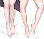  1girl barefoot bed_sheet commentary_request dakimakura_(medium) head_out_of_frame legs mignon original single_thighhigh thighhighs toes white_thighhighs 