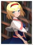  1girl alice_margatroid blonde_hair blue_dress blurry blurry_background blurry_foreground border capelet depth_of_field dress hairband highres indoors light_particles machimo red_hairband sash short_hair solo touhou white_border white_capelet window 