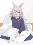  1girl alternate_costume animal_ears barefoot black_pants black_shirt blanket blue_eyes blush dot_nose fang grey_hair horse_ears long_hair long_sleeves looking_at_viewer loungewear nm222hz on_bed open_mouth pants pillow shirt sitting skin_fang smile solo tamamo_cross_(umamusume) toes twitter_username umamusume watermark 