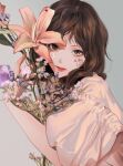  1girl bangs bouquet brown_eyes brown_hair ere_chip flower grey_background head_tilt highres holding holding_bouquet looking_at_viewer original parted_bangs pink_flower pink_shirt portrait purple_flower shirt solo 