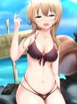  1girl absurdres animal_ears area_15 ayunda_risu bangs beach bikini breasts brown_hair cleavage cloud condom_box firen_inferno green_eyes highres hololive hololive_indonesia long_hair looking_at_viewer ocean open_mouth rock sign sitting sky solo sunlight swimsuit tail 