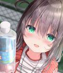  1girl :d bangs black_hair blurry blurry_background bottle chain-link_fence clothes_lift commentary_request depth_of_field fence green_eyes hair_between_eyes highres holding holding_bottle jacket kouda_suzu long_hair looking_at_viewer open_clothes open_jacket original out-of-frame_censoring red_jacket shirt shirt_lift smile solo track_jacket upper_body water_bottle white_shirt 