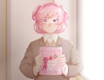  1girl blush collared_shirt commentary doki_doki_literature_club dust_particles eyes_visible_through_hair fang grey_jacket hair_ornament hair_ribbon hairclip holding hshsgen indoors jacket long_sleeves looking_at_viewer manga_(object) natsuki_(doki_doki_literature_club) nose_blush pink_eyes pink_hair red_ribbon ribbon school_uniform shirt short_hair sidelighting solo two_side_up upper_body white_shirt wing_collar 