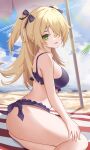  1girl :d absurdres bangs bare_arms bare_shoulders beach_towel bikini blonde_hair blue_sky bow breasts cloud commentary day feet_out_of_frame fischl_(genshin_impact) genshin_impact green_eyes hair_bow hair_over_one_eye head_tilt highres large_breasts long_hair looking_at_viewer mxr open_mouth purple_bikini purple_bow sitting sky smile solo swimsuit thighs towel two_side_up 