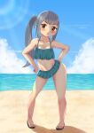  1girl absurdres beach bikini bikini_skirt blue_sky bonpiibon brown_eyes cloud commentary_request contrapposto day frilled_bikini frills full_body green_bikini grey_hair hands_on_hips highres horizon kantai_collection kasumi_(kancolle) long_hair looking_at_viewer ocean official_alternate_costume outdoors side_ponytail sky solo standing swimsuit 