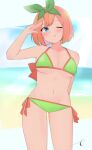  1girl ;q arm_up bangs bare_arms bare_shoulders bikini blue_eyes blue_sky blush breasts closed_mouth collarbone commentary_request day eyebrows_hidden_by_hair go-toubun_no_hanayome green_bikini green_ribbon groin hair_ribbon highres horizon kujou_karasuma looking_at_viewer medium_breasts nakano_yotsuba navel ocean one_eye_closed orange_hair ribbon short_hair side-tie_bikini_bottom signature sky smile solo swimsuit tan tongue tongue_out water 