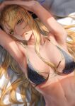  1girl :p armpits arms_up bangs bare_shoulders bed_sheet bikini black_bikini blonde_hair breasts chin_piercing cleavage collarbone commentary_request dark-skinned_female dark_skin dragon_girl dragon_horns facial_mark fang fate/grand_order fate_(series) horns large_breasts long_hair looking_at_viewer lying medium_breasts mugetsu2501 navel on_back smile solo swept_bangs swimsuit tongue tongue_out upper_body vritra_(fate) vritra_(ocean_flyer)_(fate) yellow_eyes 