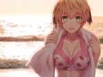  1girl beach bikini blonde_hair breasts commentary_request fate/grand_order fate_(series) food_print gareth_(fate) gareth_(swimsuit_saber)_(fate) gareth_(swimsuit_saber)_(second_ascension)_(fate) green_eyes highres medium_breasts murasame_shia ocean pink_bikini short_hair signature strawberry_print sunset swimsuit towel towel_around_neck wet 