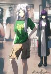 2girls absurdres alternate_costume artist_name cargo_shorts clothes_shop contemporary elf fern_(sousou_no_frieren) frieren green_eyes green_shirt green_zelda_shirt_and_cargo_shorts_(meme) hand_on_own_hip highres indoors long_hair mayushuuu meme multiple_girls pointy_ears purple_hair shirt shopping shorts sousou_no_frieren standing t-shirt the_legend_of_zelda triforce_print trying_on_clothes twintails white_hair 