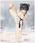  1girl absurdres barefoot belt black_belt black_hair border chinese_commentary closed_mouth commentary_request double_bun dougi full_body hair_bun highres kuma-bound looking_at_viewer martial_arts_belt medium_hair original outdoors pants smile snowing soles solo standing standing_on_one_leg toes tree white_border white_pants winter yellow_eyes 