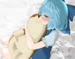  1girl bare_legs blue_bow blue_dress blue_eyes blue_hair blush bow cirno closed_mouth dress fairy hair_bow highres hugging_doll hugging_object ice ice_wings looking_at_viewer mikan_(manmarumikan) shirt short_hair short_sleeves solo stuffed_animal stuffed_dog stuffed_toy touhou white_shirt wings 