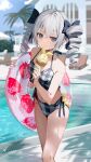  1girl bikini black_bow blurry blurry_background bow bronya_zaychik drill_hair grey_eyes grey_hair hair_between_eyes hair_bow highres holding holding_ice_cream holding_innertube homu_(honkai_impact) honkai_(series) honkai_impact_3rd ice_cream_cone innertube looking_at_viewer motto_(night_wear) outdoors pool solo standing swimsuit twin_drills twintails water wet 