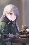  1girl bangs black_gloves blurry blurry_background cake candy character_name chocolate chocolate_bar closed_mouth dessert doughnut elbow_rest food fork girls&#039;_frontline gloves green_jacket hair_behind_ear hair_between_eyes happy_birthday head_on_hand head_rest highres holding jacket long_hair long_sleeves looking_at_viewer mg4_(girls&#039;_frontline) ranyu sitting solo table truffle upper_body yellow_eyes 