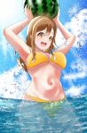  1girl :d arms_up bikini blue_sky breasts brown_hair commentary day food fruit highres holding holding_food holding_fruit kunikida_hanamaru long_hair looking_at_viewer love_live! love_live!_sunshine!! medium_breasts momouninego navel outdoors partially_submerged sky smile solo swimsuit teeth upper_teeth yellow_bikini 