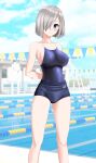  1girl absurdres alternate_costume arms_behind_back blue_buruma blue_eyes blue_one-piece_swimsuit blue_sky breasts buruma cloud commentary_request competition_school_swimsuit day feet_out_of_frame grey_hair hair_ornament hair_over_one_eye hairclip hamakaze_(kancolle) highres kantai_collection lane_line large_breasts looking_at_viewer outdoors parted_lips pool school_swimsuit short_hair sky solo string_of_flags swimsuit swimsuit_under_clothes takafumi 