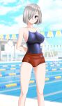  1girl absurdres alternate_costume arms_behind_back blue_eyes blue_one-piece_swimsuit blue_sky breasts buruma cloud commentary_request competition_school_swimsuit day feet_out_of_frame grey_hair hair_ornament hair_over_one_eye hairclip hamakaze_(kancolle) highres kantai_collection lane_line large_breasts looking_at_viewer outdoors parted_lips pool red_buruma school_swimsuit short_hair sky solo string_of_flags swimsuit swimsuit_under_clothes takafumi 