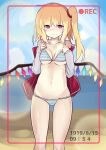  1girl absurdres bangs bikini blonde_hair blush closed_mouth crystal feet_out_of_frame flandre_scarlet furrowed_brow highres long_sleeves looking_at_viewer medium_hair ocean one_side_up red_eyes red_vest sand smile solo standing striped striped_bikini swimsuit te_toga touhou vest white_sleeves wings 