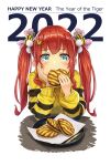  1girl 2022 animal_print bangs blue_eyes blush chinese_zodiac eating elbow_rest food food_request fukukitaru hair_ornament hair_ribbon hand_on_own_cheek hand_on_own_face happy_new_year highres holding holding_food long_hair long_sleeves looking_at_viewer nengajou new_year original plate pom_pom_(clothes) pom_pom_hair_ornament red_hair ribbon smile solo sweater tiger_hair_ornament tiger_print twintails year_of_the_tiger 