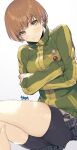  1girl bike_shorts blush breasts brown_eyes brown_hair closed_mouth crossed_arms green_jacket highres jacket looking_at_viewer murata_tefu persona persona_4 satonaka_chie short_hair simple_background skirt solo track_jacket white_background 