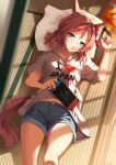  1girl absurdres animal_ears blue_eyes bow braid brown_hair collarbone commentary_request crumbs food food_on_face french_commentary hair_between_eyes handheld_game_console highres holding holding_handheld_game_console horse_ears horse_girl horse_tail looking_at_viewer lying midriff_peek navel nintendo_switch on_back open_mouth pillow shirt shorts solo sunny_(20597521) tail tatami umamusume venus_paques_(umamusume) white_shirt 