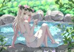  bangs barefoot bikini blonde_hair blurry blurry_foreground commentary_request flower from_behind green_eyes hair_between_eyes hair_flower hair_ornament hand_on_ground head_wreath highres holding holding_jewelry holding_necklace jewelry lens_flare long_hair looking_at_viewer necklace open_mouth original outdoors pink_flower rock side-tie_bikini_bottom sitting swimsuit syimo thighs tree water wet white_bikini 