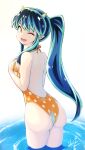  1girl ;d animal_print ass backless_swimsuit bangs breasts commentary_request from_behind green_hair hori_shin horns long_hair looking_at_viewer lum medium_breasts one_eye_closed oni partially_submerged pointy_ears polka_dot polka_dot_swimsuit ponytail smile solo swimsuit thighs urusei_yatsura 