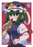  1girl 6gd7b blue_headwear border breasts frilled_hat frills ghost green_eyes green_hair hat highres holding juliet_sleeves long_sleeves looking_at_viewer puffy_sleeves red_background rod_of_remorse shiki_eiki short_hair simple_background solo touhou upper_body white_border 
