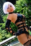  asian breasts christie christie_(doa) cleavage cosplay criss-criss_top criss_cross_top dead_or_alive earrings elbow_gloves fishnets gloves jewelry latex photo real tecmo thighhighs vinyl white_hair yaya_han 