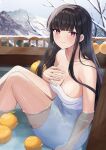  1girl black_eyes black_hair breasts collarbone food fruit hand_on_own_chest highres knees_up kurousagi_yuu long_hair looking_at_viewer medium_breasts naked_towel onsen orange_(fruit) original partially_submerged sitting smile snow solo towel water 