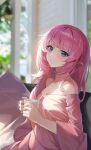  1girl absurdres bangs bare_shoulders blue_eyes blurry blurry_background breasts cleavage closed_mouth commentary_request couch cup depth_of_field elysia_(honkai_impact) highres holding holding_cup honkai_(series) honkai_impact_3rd indoors long_hair medium_breasts mo_ying_yu off-shoulder_shirt off_shoulder on_couch pillow pink_hair pink_shirt pointy_ears shirt sitting smile solo spoon very_long_hair 